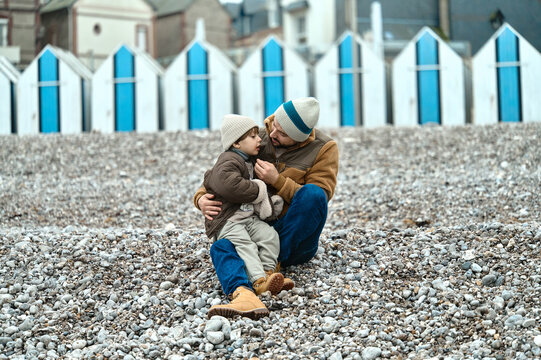 father with son on a normand beach