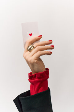 A playing card in a woman's hand