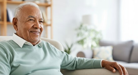 Fototapeta premium Elderly african male relaxing at home in comfortable sweater