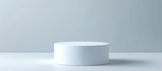 A solitary white cylindrical platform against a plain background