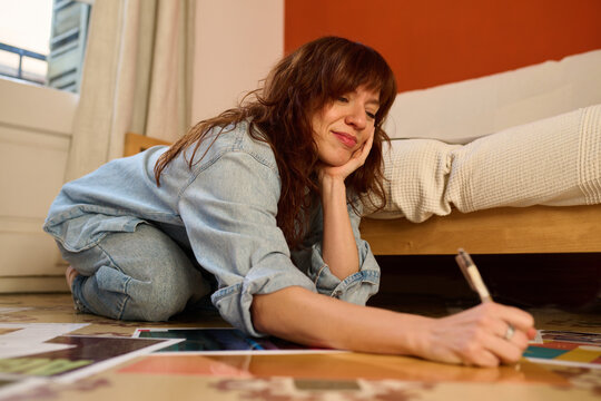 freelancer is deep in thought while sketching ideas
