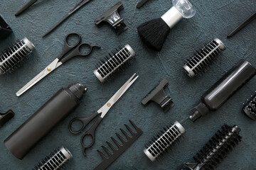 Set of hairdresser's accessories on dark grunge background