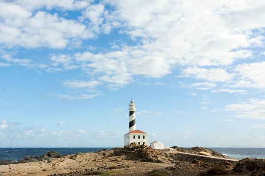 Beautiful lighthouse on rocky Menorca coastline  - Powered by Adobe