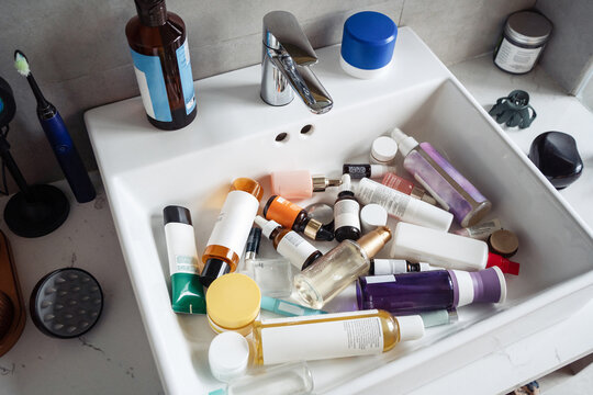 Overhead shot: sink filled with skincare products