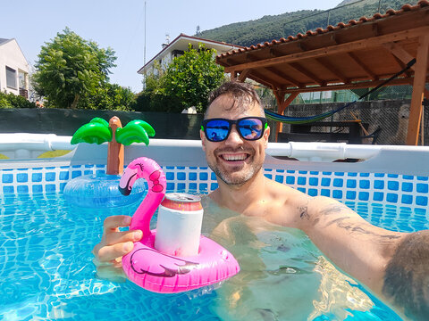 Man enjoying summer refreshing in swimming pool