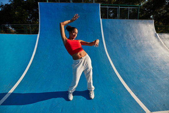 Woman dancing on skate ramp