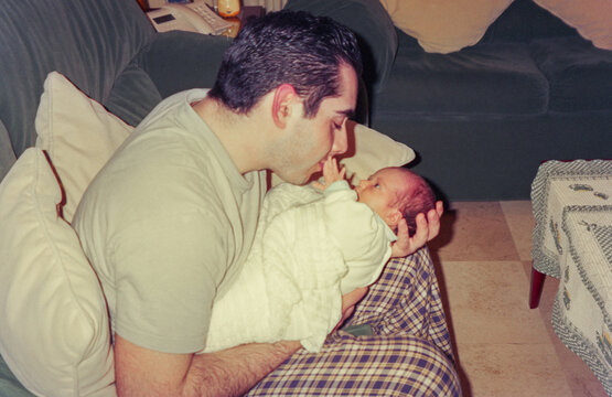 analog image of father with newborn in his arms