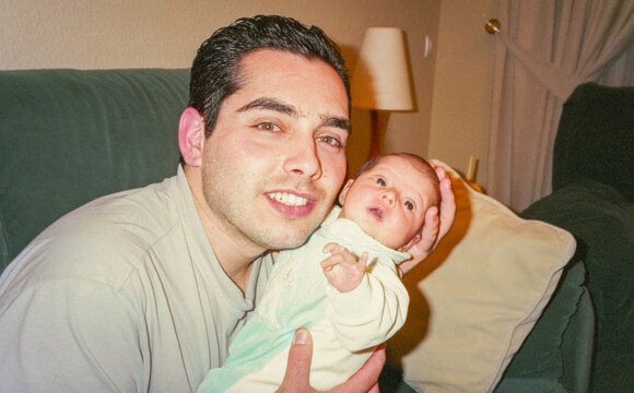 analog image of father with newborn in his arms