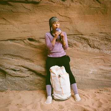 Woman having a snack in Buckskin Gulch