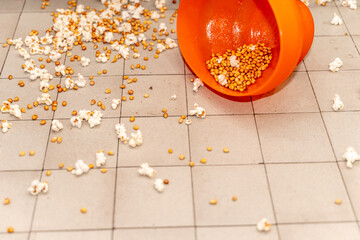 Spilled Popcorn and Kernels. Kitchen Tiled Floor