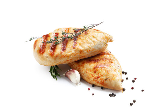Tasty grilled chicken breast with rosemary, thyme, peppercorns and garlic on white background