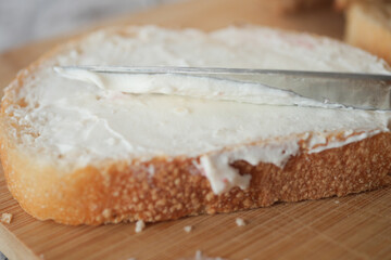 Freshly spread butter on a slice of bread in a cozy kitchen