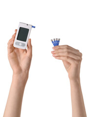 Woman holding digital glucometer and test strips on white background