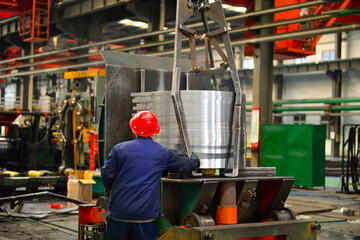Workers on the production line of the strip steel coil factory are working