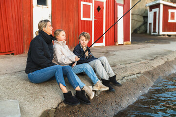 Family Enjoying a Winter Day Fishing by the Pier