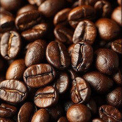 Fototapeta premium A close-up view of a rich pile of roasted coffee beans, showcasing their glossy, dark brown surface and unique textures, set against a smooth, deep black background for striking contrast.