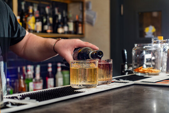 Bartender prepares cocktail at the bar counter