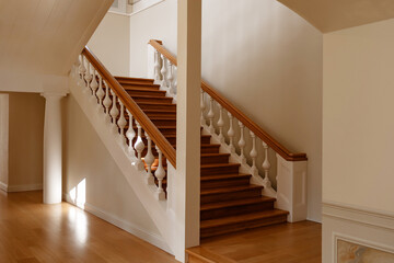 A beautifully crafted wooden staircase with ornate balusters in a historic mansion. Perfect for...
