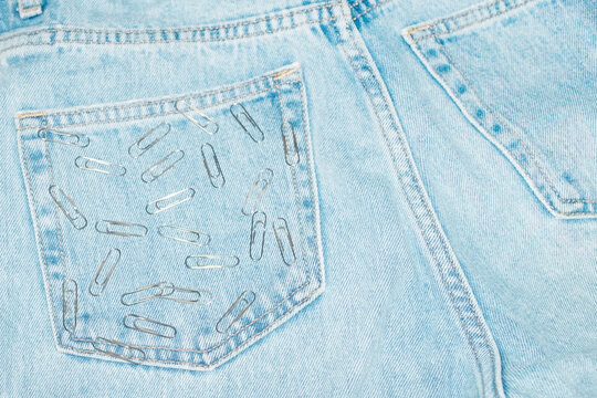 Blue classic jeans and silver paper clips on pocket with flash