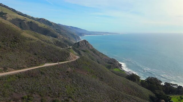 Stunning aerial footage captures Highway 1 as it gracefully winds through the stunning Big Sur coastline in California, beautifully revealing the unparalleled and aweinspiring beauty of nature