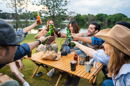 Group of diverse friend having outdoors camping party together in tent. 