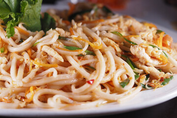 Noodles with vegetables and chicken served at a restaurant