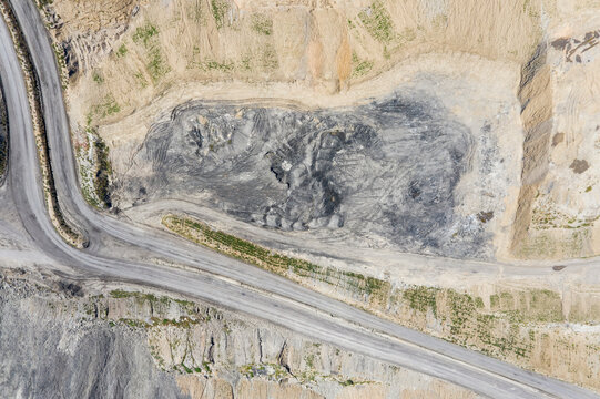 Aerial Open-Pit Coal Mine View with Exposed Layers and Winding R