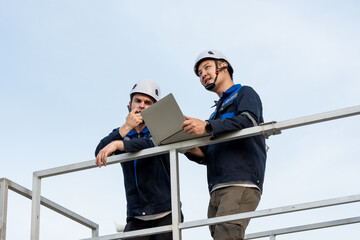 Diverse male technicians working to maintenance outdoors warehouse. 