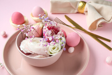 Stylish table setting for Easter celebration with different flowers on pink background
