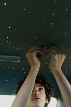 A teenage boy installs Starlights in his car