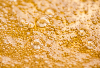 Golden syrup with air bubbles forming delicate pattern