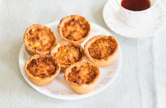 Freshly Baked Tartlets on a Plate with Tea