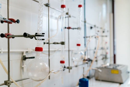 Chemical equipment hanging on a metal structure in laboratory setting
