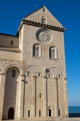 Trani Cathedral, a stunning Romanesque masterpiece in Apulia, Italy, stands majestically by the Adriatic Sea, showcasing its elegant limestone façade and historic charm.