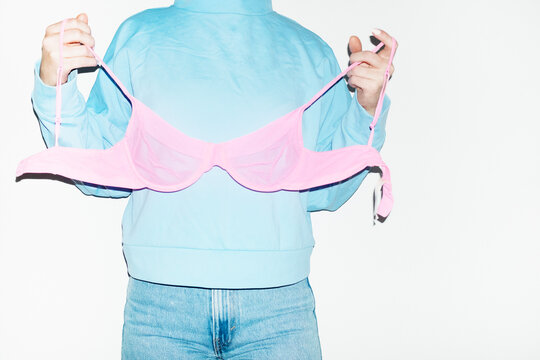 Wearing clothes wrong way: pink underwear lingerie bra top of shirt