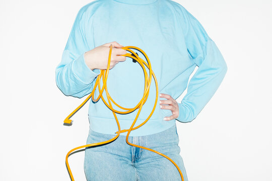 Person holding a curvy electronic tech wire with hard direct flash