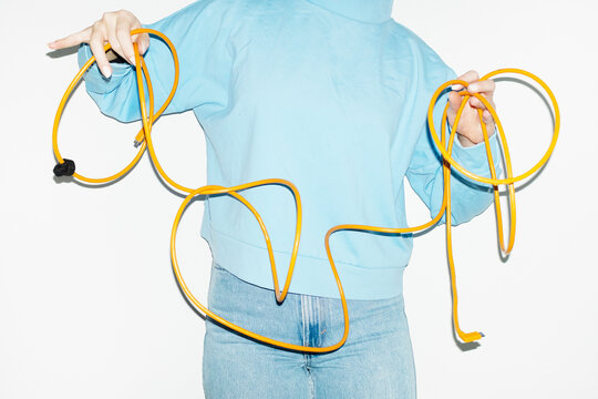 Person holding a curvy electronic tech wire with hard direct flash