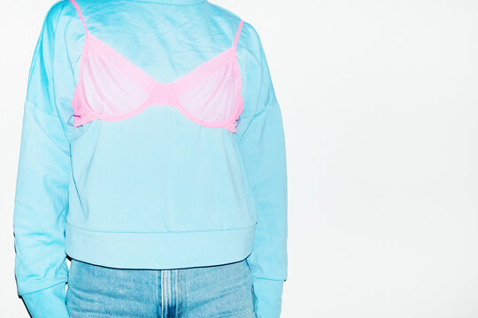 Wearing clothes wrong way: pink underwear lingerie bra top of shirt