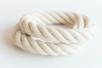 White Twisted Cotton Rope on Solid Background for Crafts, Decoration, or Nautical Theme