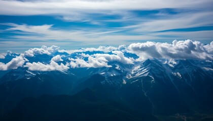 Obraz premium Majestic Snowy Mountains Under Blue Sky with Fluffy Clouds Landscape