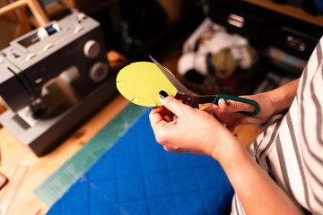 Hands Cutting Circular Template with Scissors