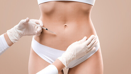 Beauty procedure for body. Slim lady having lipolysis treatment at beauty salon, closeup