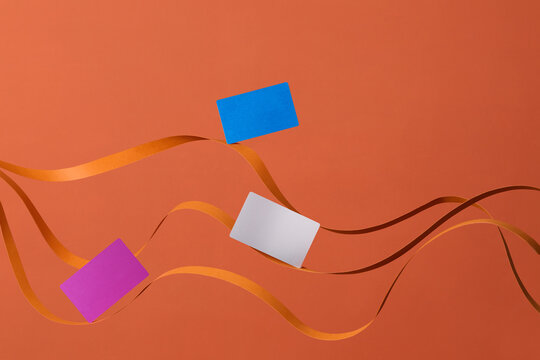 Colorful Cards with Ribbon on a Vibrant Orange Background