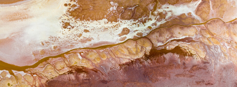 Mineral colors and patterns from drying salt in rural lake bed
