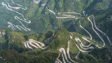 A unique mountain serpentine road with 99 turns. The highway winds along steep wooded slopes,...