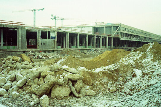 Construction site with heavy machinery and materials in urban area