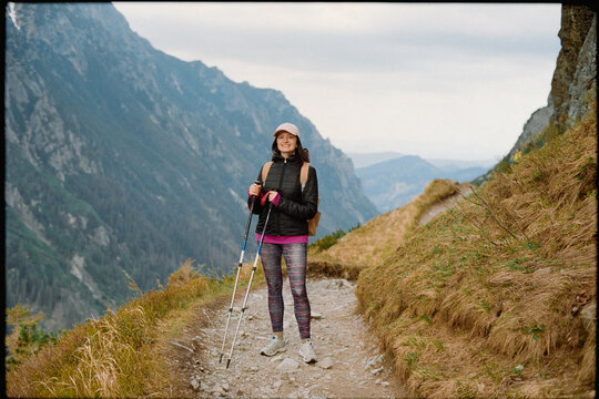 A girl smiles on a mountain hike