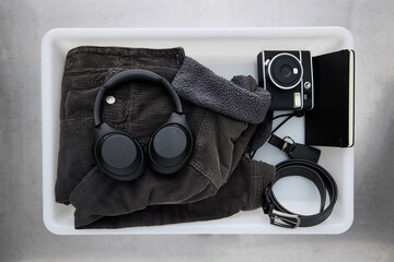 Airport check-in tray with personal items before traveling
