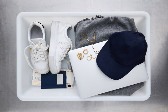 Items Organized in a Tray for Security Check at an Airport
