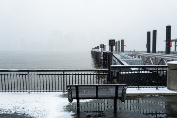 Snowy Bench Facing Waterfront Pier